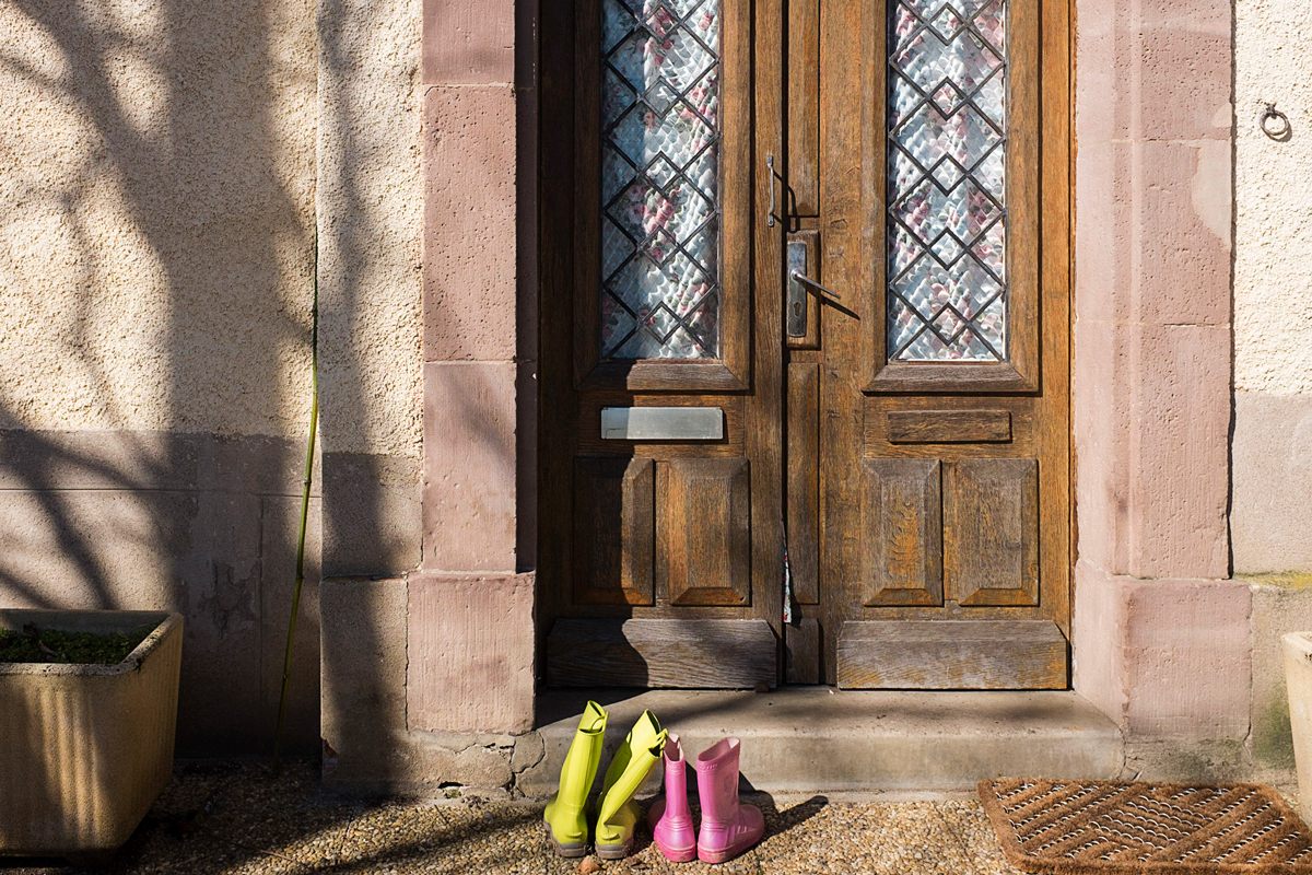 Childrens' boots placed outside while the family breaks for lunch.