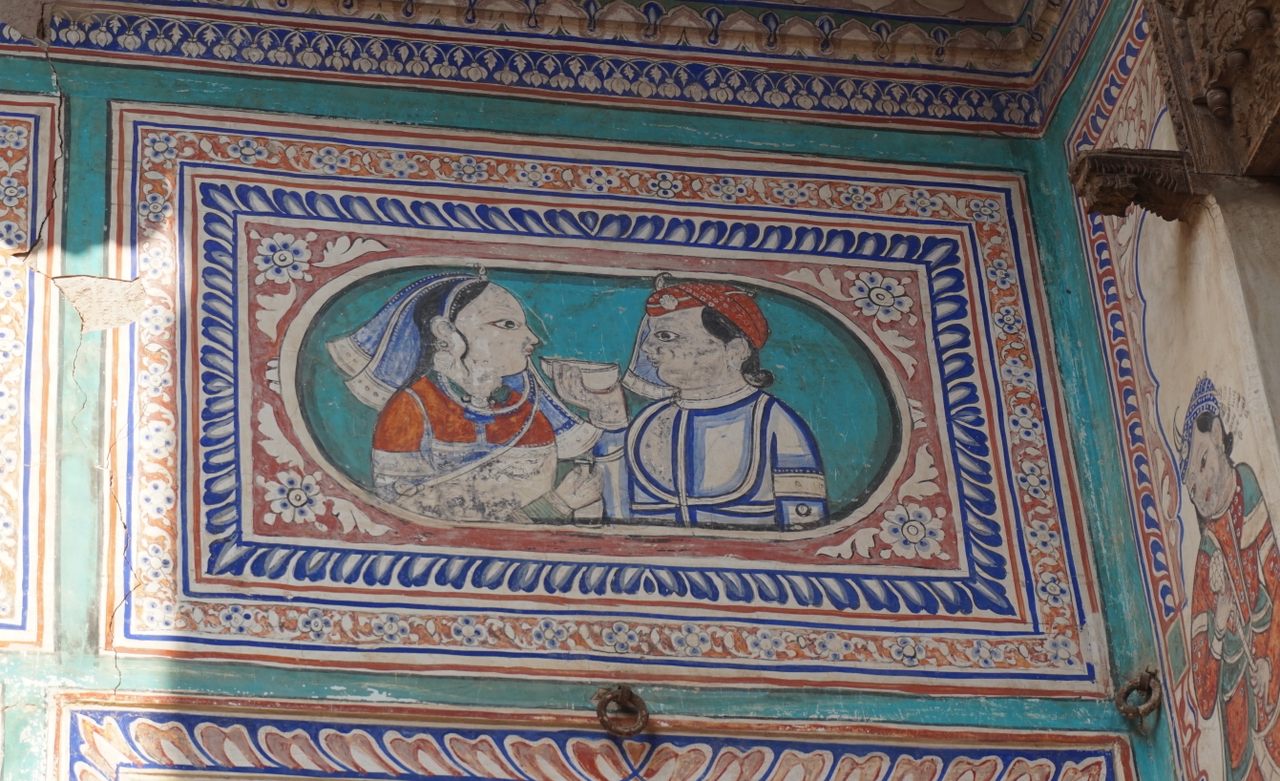 A fresco from a mansion, or haveli, depicting the sharing of a drink. In Rajput culture, the munawwar piyala meaning "cup of request" is liquor offered to guests during gatherings, especially marriages.