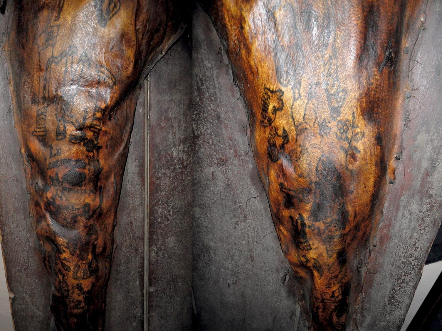Monsieur Bonheur's lower limbs include "upside down" tattoos that would have been correctly oriented to him when seated, suggesting he may have tattooed these designs himself.