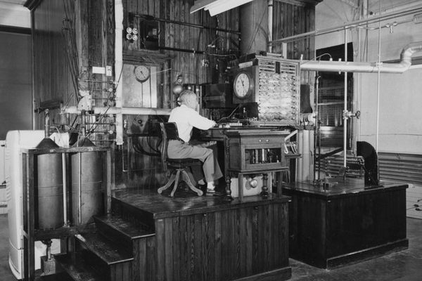 A researcher performing an experiment on animal nutrition using the Armsby Respiration Calorimeter in the early 1900s.