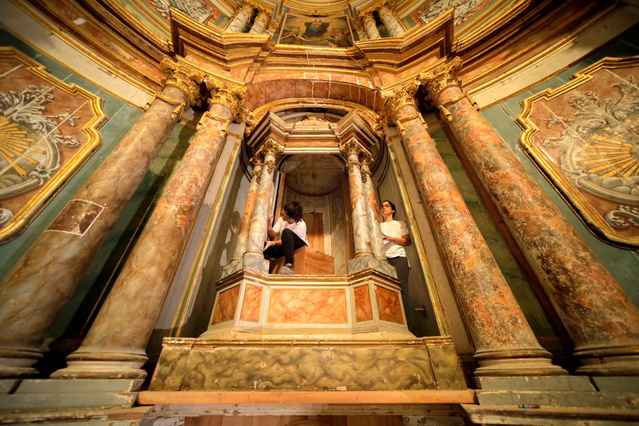 Restorers work on the altarpiece at the Catedral Basílica Santa María la Antigua in Panama City.