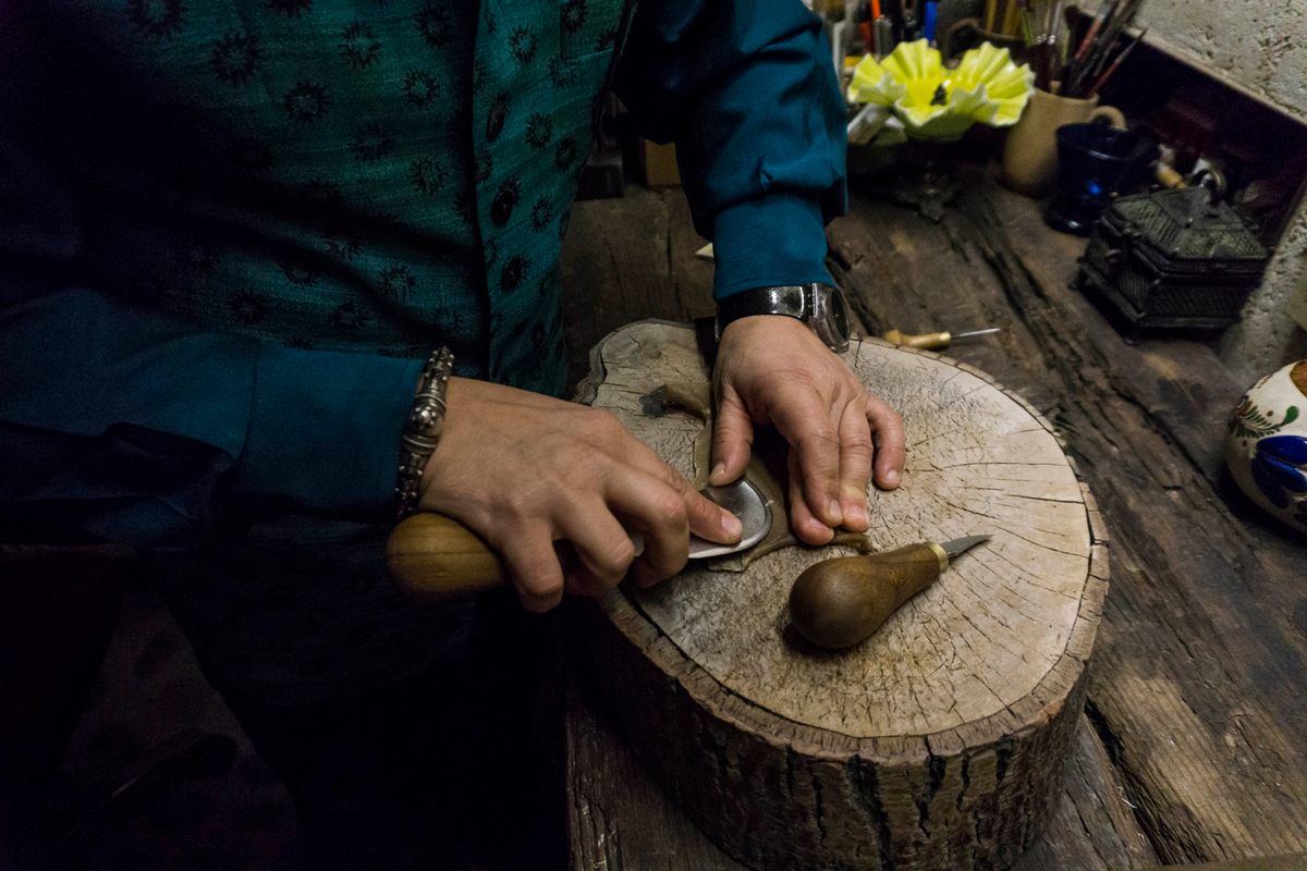 Using thin pieces of camel leather, Özek prepares to fashion another shadow theater puppet.
