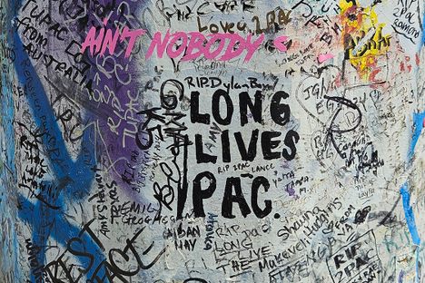 Graffiti on the utility pole pays homage to the late Tupac Shakur.