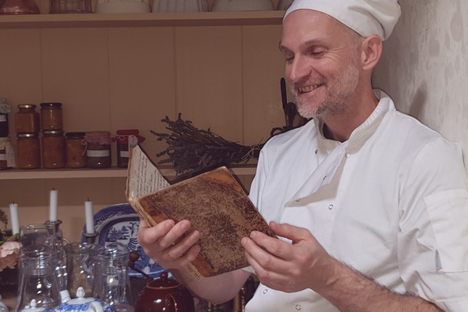 Paul Couchman holds the manuscript cookbook.