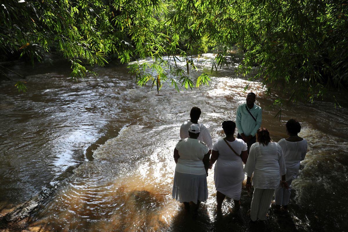 Tourists gather at Assin Manso, where slaves were given a last bath after a long journey.
