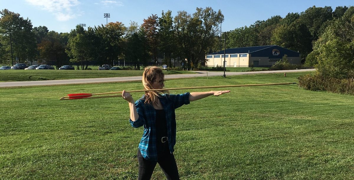 Lead author and experimental archaeologist Michelle Bebber holds an atlatl loaded with a six-foot dart.