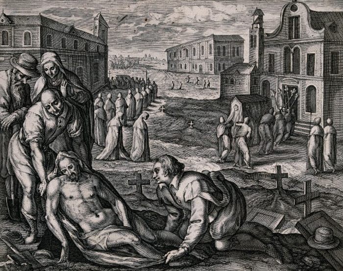 A male corpse is wrapped in linen as a funeral processes into a church in the background, early 1600s.