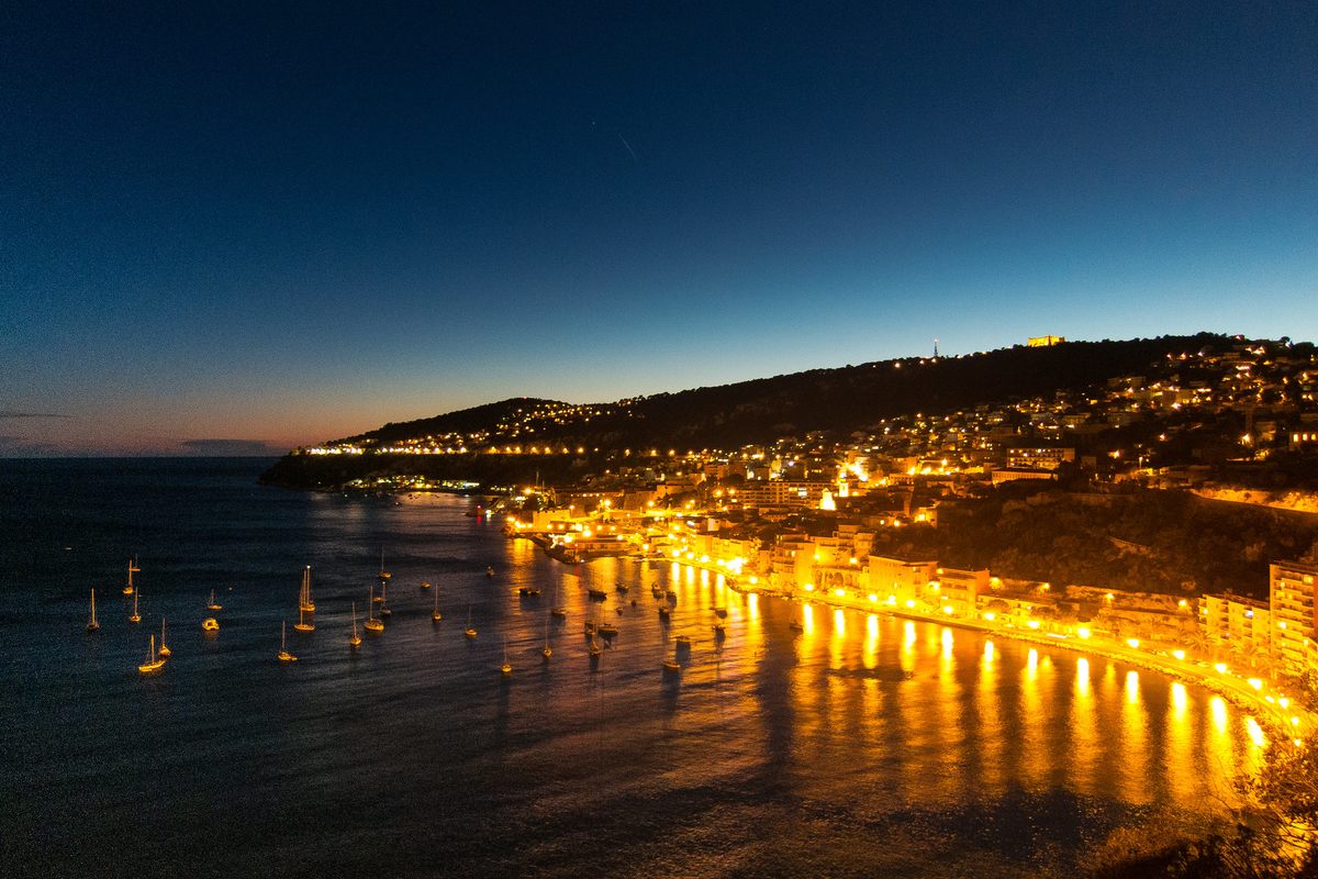 A nighttime view of the waterfront along the bay of Villefranche-sur-Mer, where purple sea urchins are abundant, often on the menu, and occasionally stepped on.