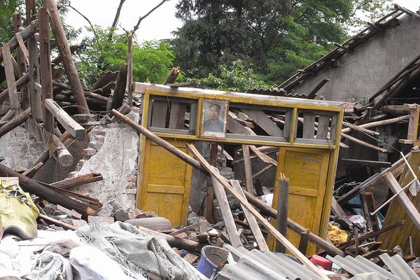 A portrait of Chairman Mao remained standing in a pile of debris.