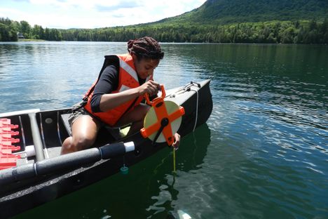 A National Lakes Assessment volunteer tests the transparency of a lake in 2012.