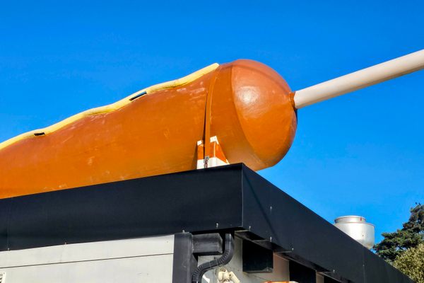 The World's Largest Corn Dog is a 30-foot-long fiberglass structure on the roof of the Original Pronto Pup.