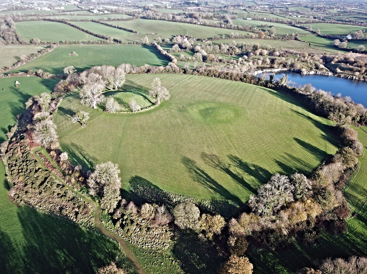 The hilltop remains of Navan Fort, an Iron Age site that a new paper argues has a broader history than previously thought.