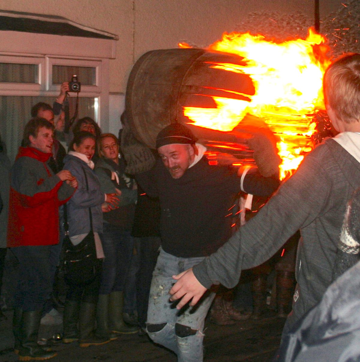 Locals race flaming tar barrels through the streets of Ottery Saint Mary.