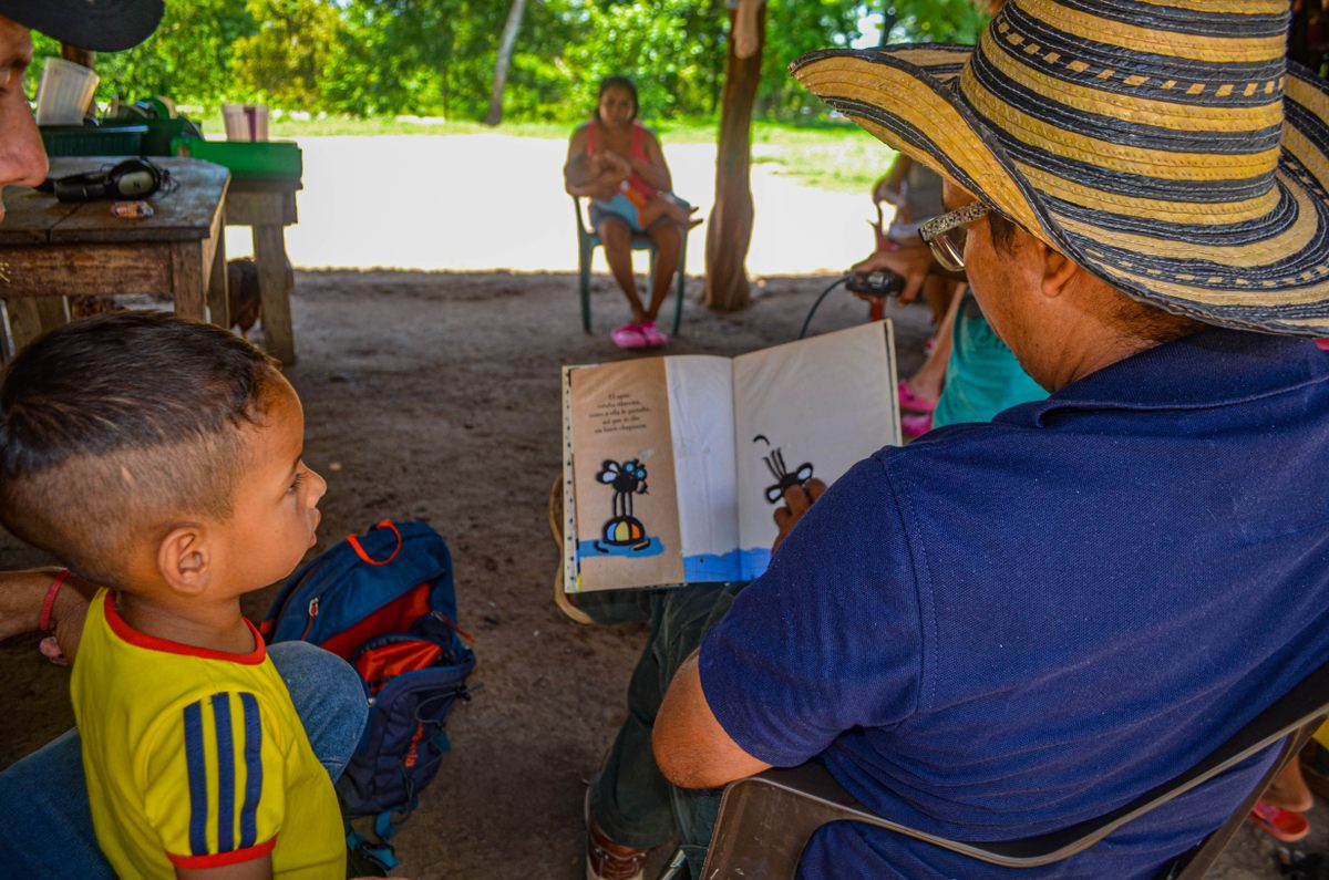 Soriano often pauses to read to children as he delivers books.