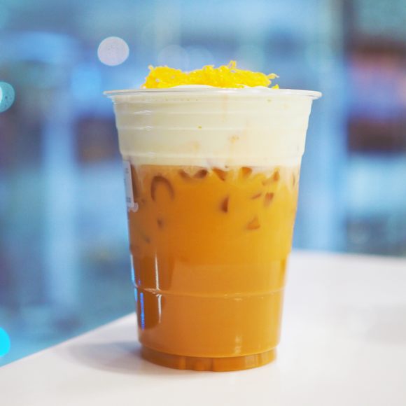 A cup of iced oolong with cheese foam and egg floss.