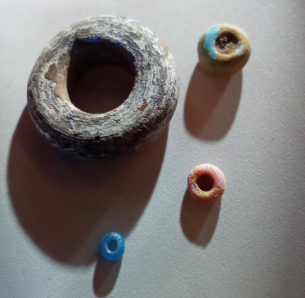 These four beads were found in the Kasitu Valley in northern Malawi. The biggest is about the size of a Cheerio, while the smallest is the size of a grain of rice.