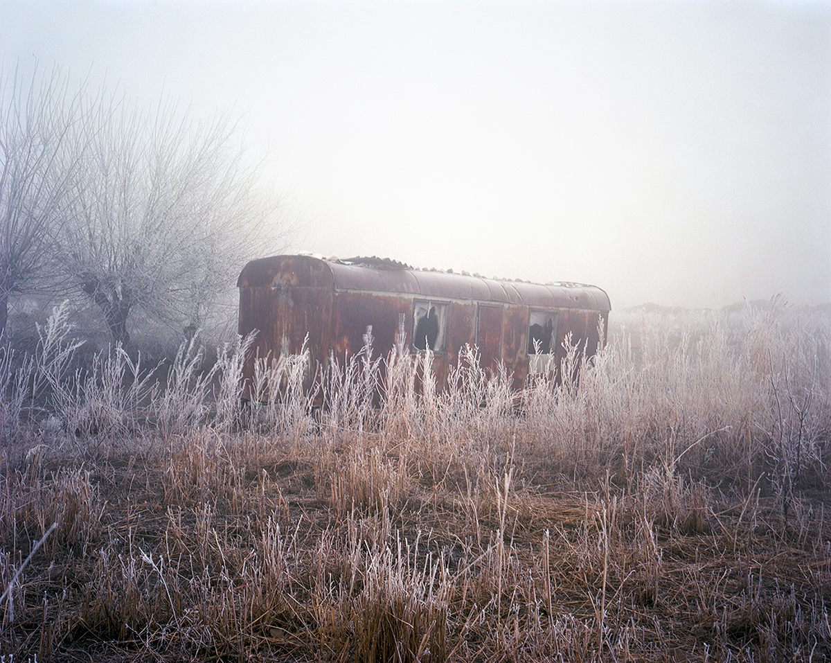 An abandoned trailer in the frost of Mailuu Suu. 