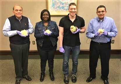 John Bell stands on the far left holding his heart with three other transplant patients at Baylor University Medical Center.