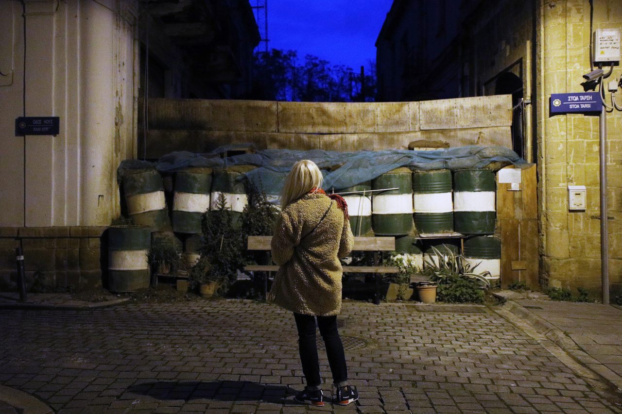 A young woman stands near the barricades of the U.N. buffer zone in the Greek-Cypriot part of Nicosia.