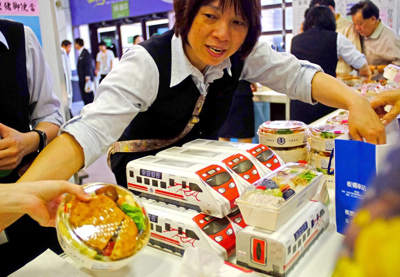 Taiwan Railway staff sorts out lunch boxes at the 2016 Taiwan Culinary Exhibition in Taipei.