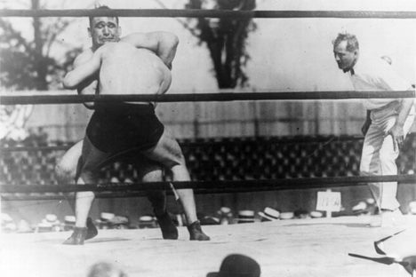 Ed Lewis applying his signature move, the headlock, on Ivan Linow in 1920. Lewis went on to be defeated by newcomer Wayne Munn in 1925.