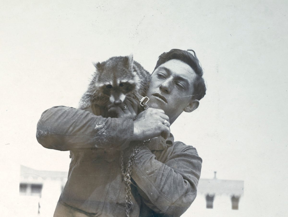 A raccoon on the shoulder of a soldier stationed at Carlstrom Aviation Field in Arcadia, Florida.