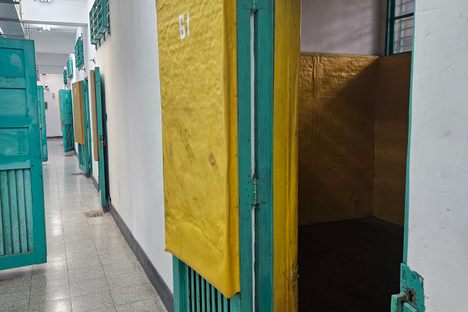The fading padded walls on dispay in a cell of the prison.