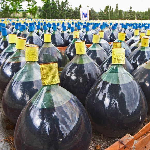 Rows of glass demijohns of Rivesaltes. 