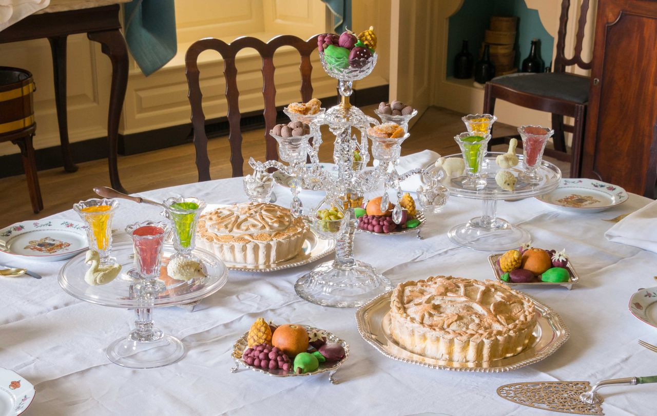 The Governor’s Palace dining room in Colonial Williamsburg filled with fake jellies, candied ginger, chocolate almonds, pies, and marzipan fruits and animals.