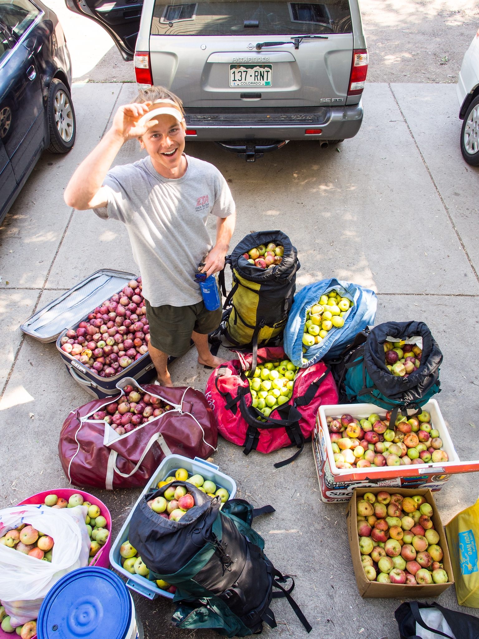 Wanner stands among the 500 pounds of apples he picked from trees with Welty in Boulder. The duo pressed the apples into cider.