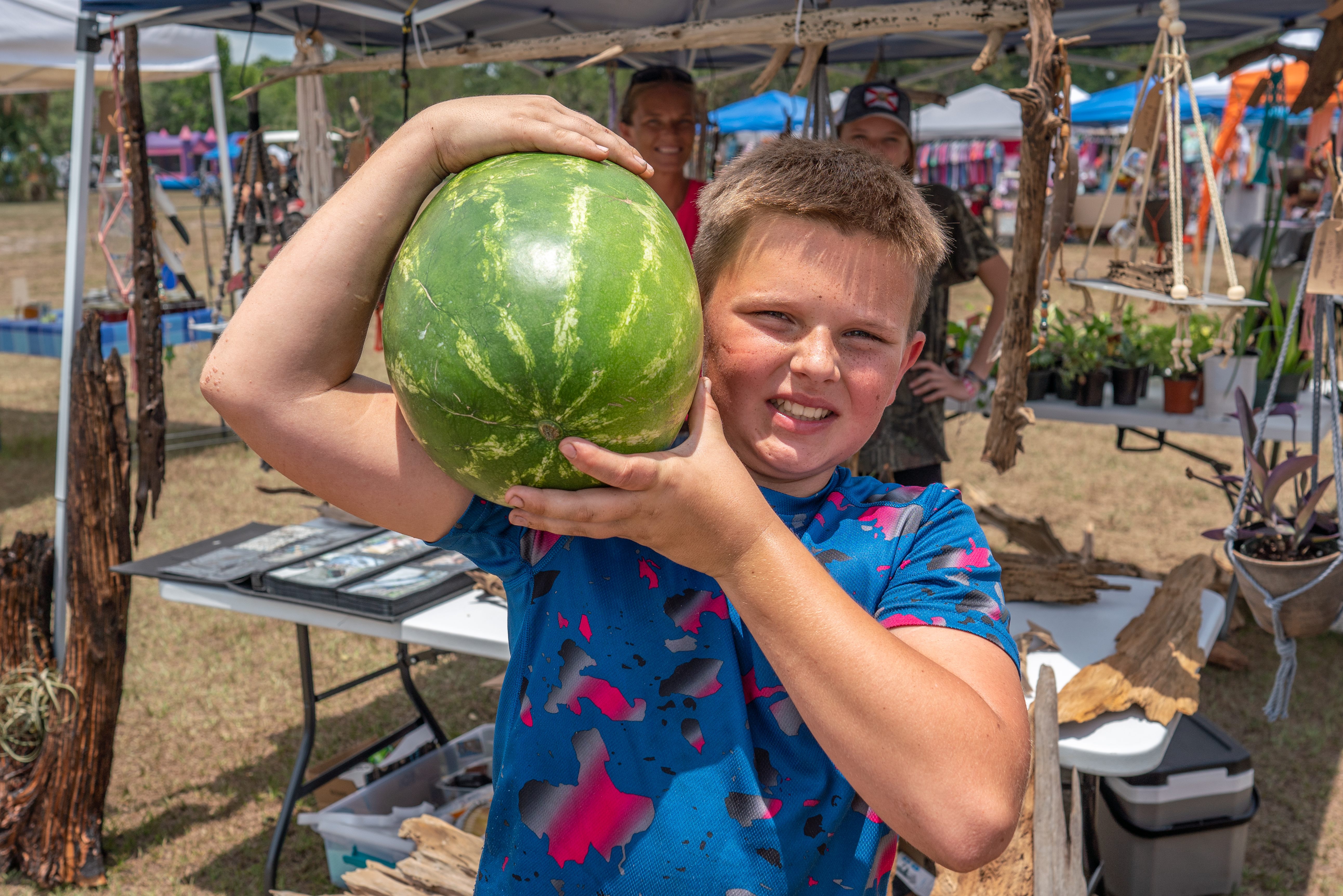 A young boy proudly displays his watermelon at the Watermelon Festival.