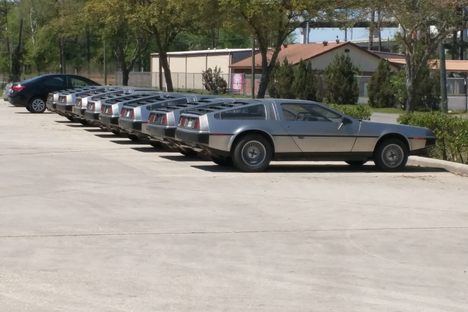 DeLoreans line up outside the repair facility.