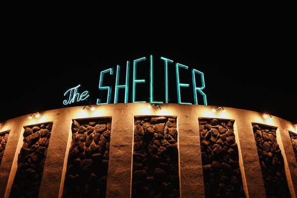 The Shelter lit up at night