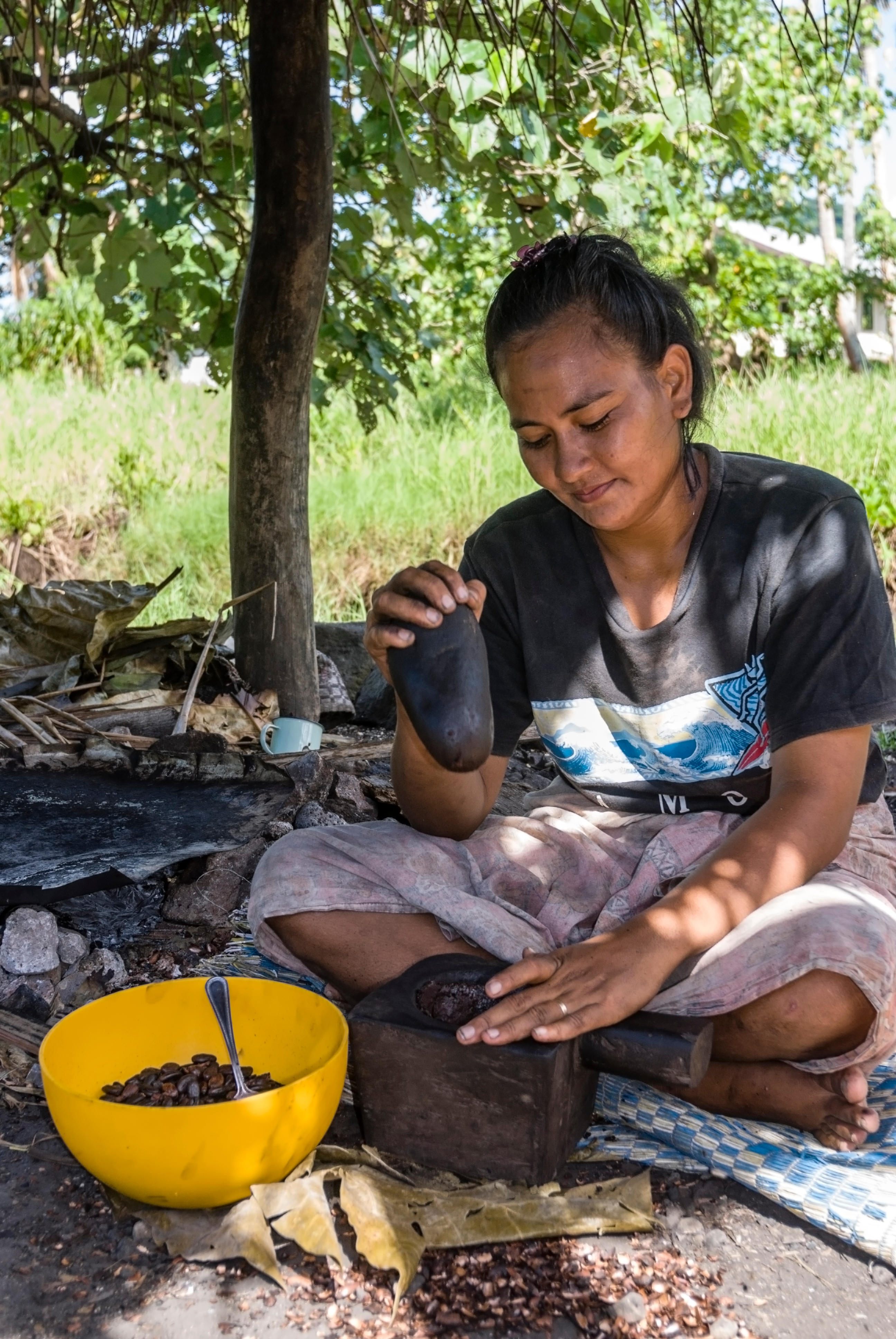Crushing cacao is the first of many steps leading to a cup of koko.