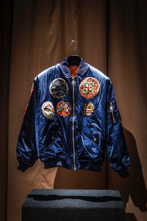 Akitoshi's flight jacket. In the story, it was designed by his wife, Akiko Fushiyama, who hoped the patches would stand in for real mission experience; in real life, Rubio made them out of old kimonos with the help of local women.