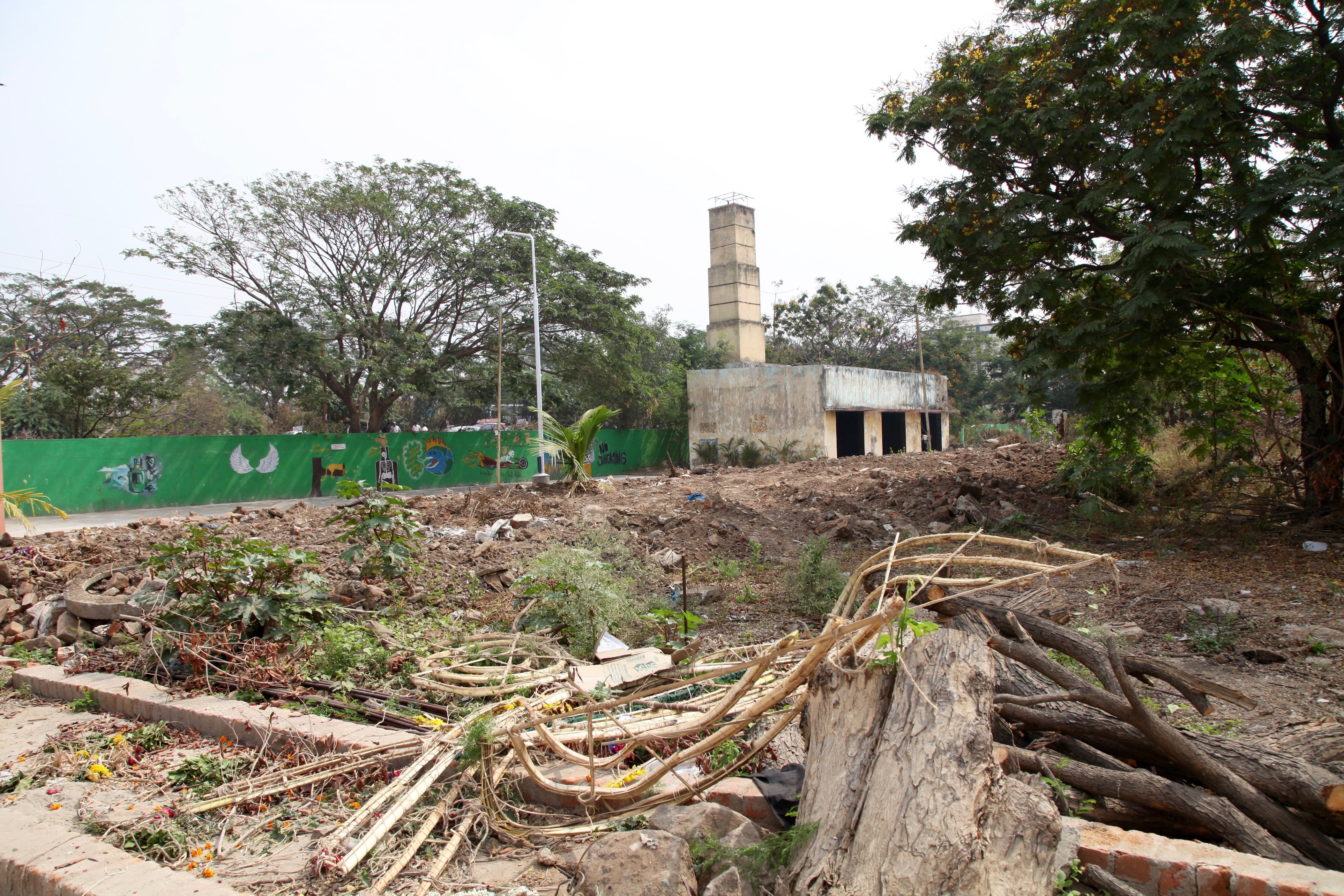 A disused burial ground is being leveled and turned into a park. In the background is the old cremation chamber where bodies were burnt on wooden pyres.