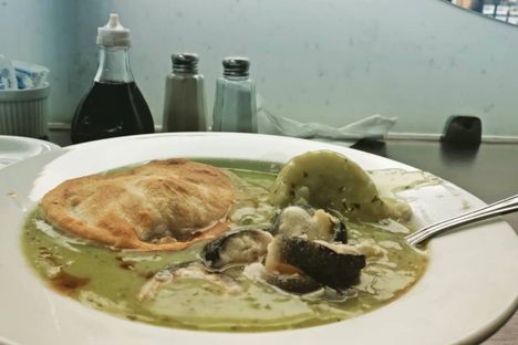 Pie, mash, and eel in parsley sauce.