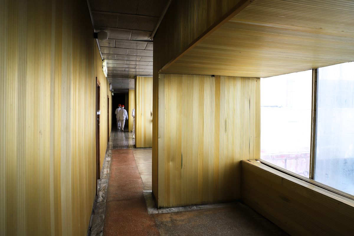 A tour group makes their way down Reactor 2’s Golden Corridor.