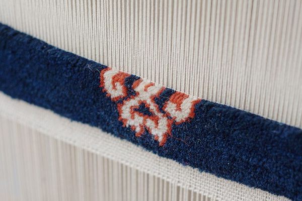 A carpet loom in action.