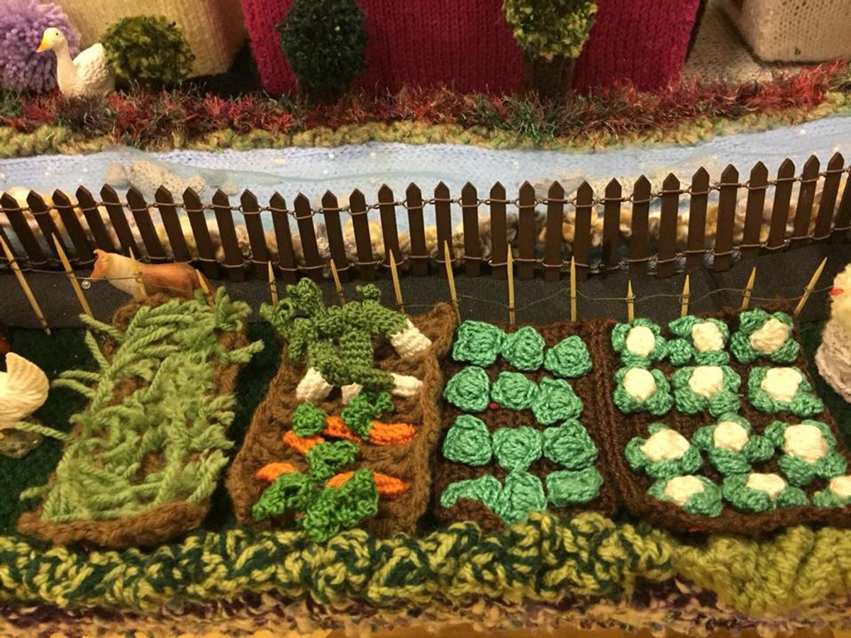 Tiny vegetables grow in the model village's gardens.