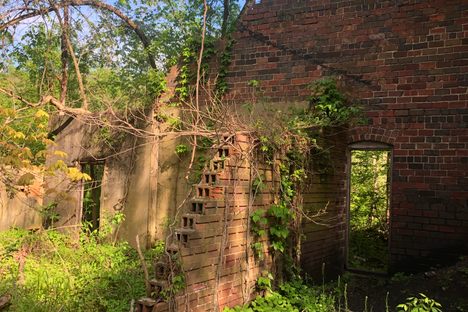 A few walls are still standing at the base of the chimney. The mine ceased operations in May, 1945.
