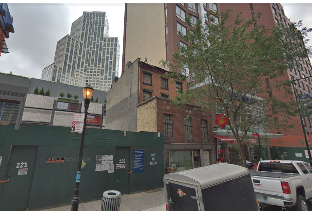 The Truesdell house in August 2018, sandwiched between a high-rise hotel and a lot that will become a park.