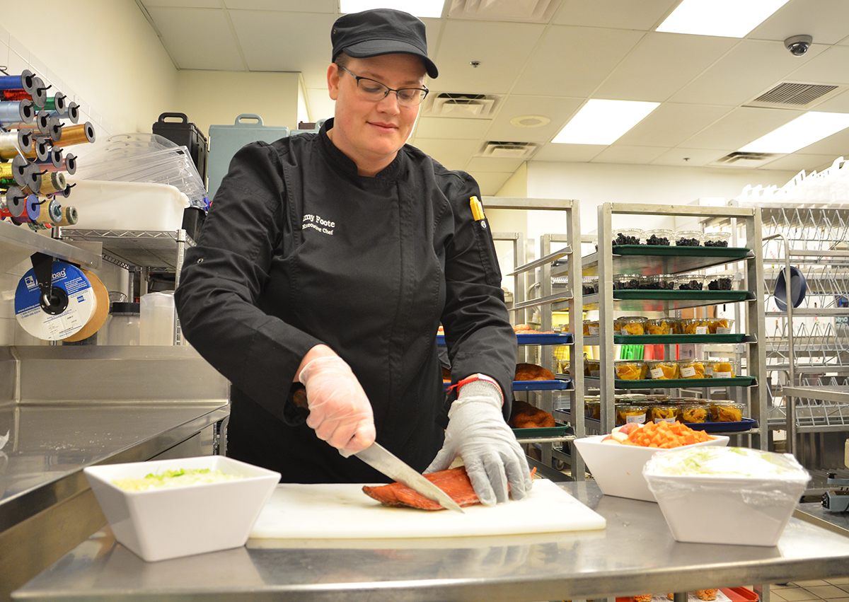 Chef Amy Foote preparing fresh Alaskan salmon for soup.