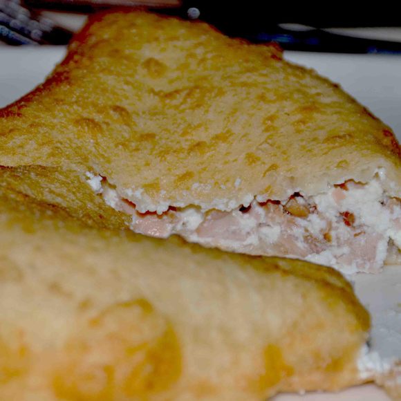 A pizza fritta stuffed with ricotta and cicoli (fatty pork).