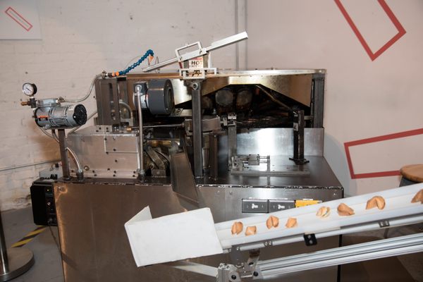 A machine for making fortune cookies on display.