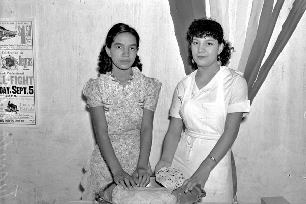 Juanita (left) and Esperanza Garcia make tortillas in this photograph from 1937.