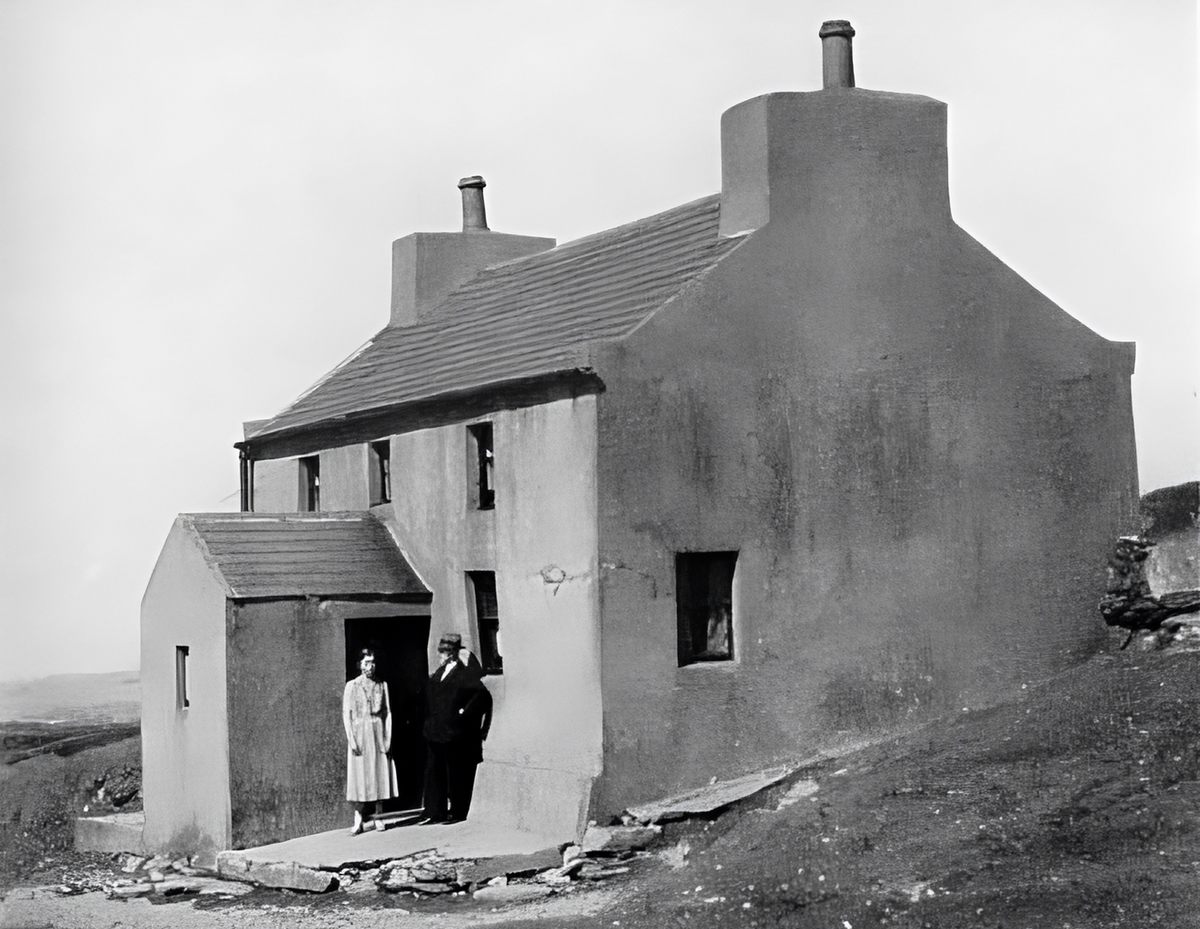 James Irving (right) and his daughter, Voirrey (left), stand in front of their home on the Isle of Man.