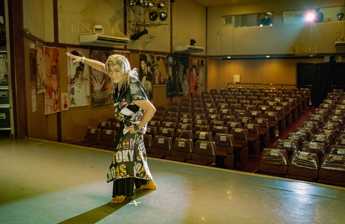 A <em>zachou</em>, or troupe leader, poses on stage after a show.