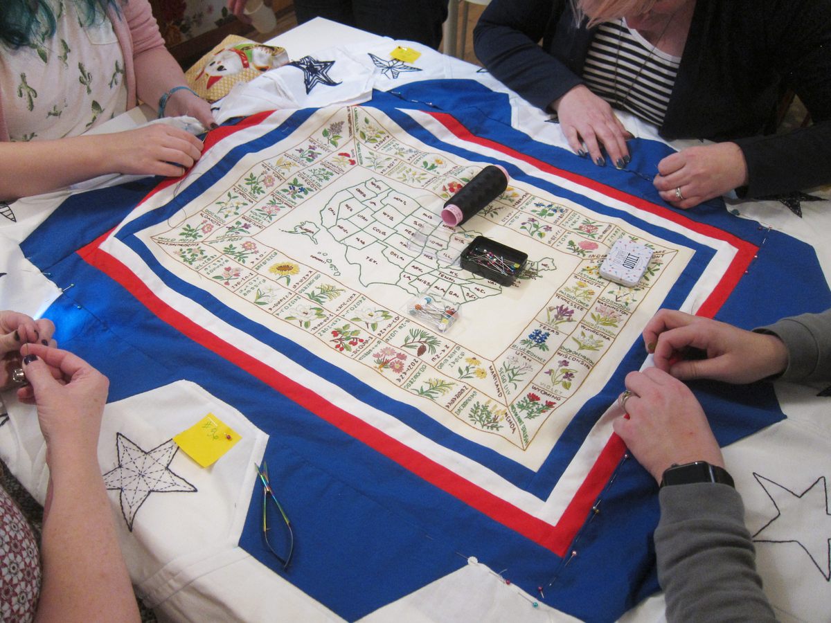 Participants sew the hexagons to Rita's original, finished map.