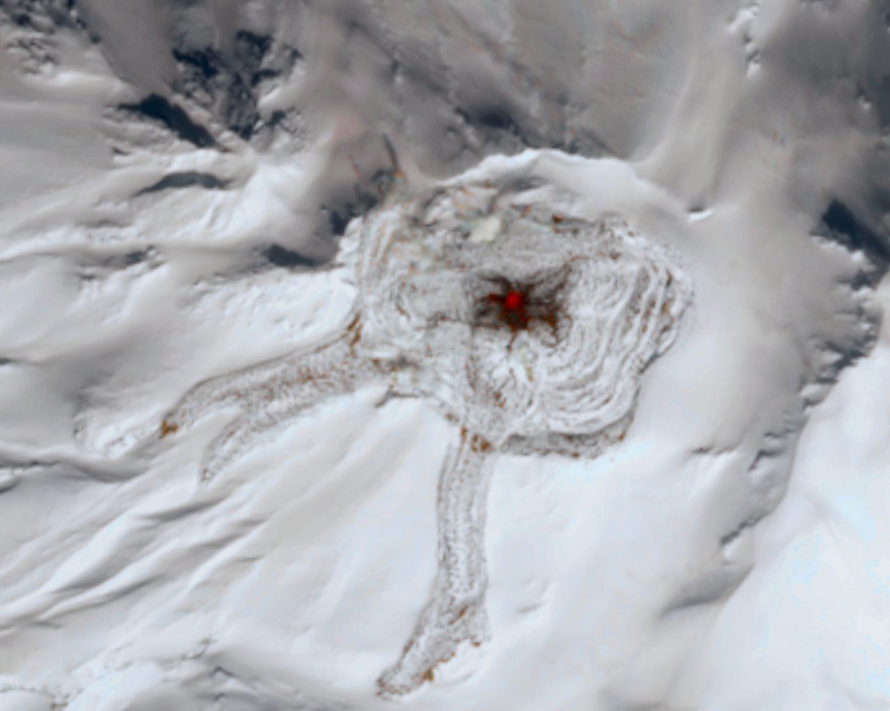 Alaska's Great Sitkin volcano, shown here in a satellite image from April 8, has been erupting for several months.